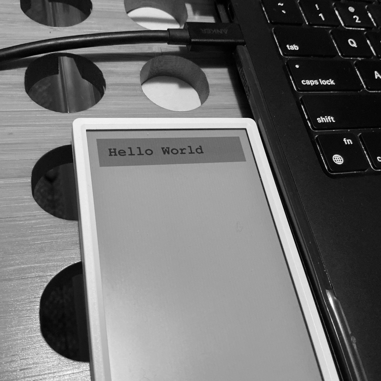 My M5 Paper next to my laptop. The paper has a header that says hello world.